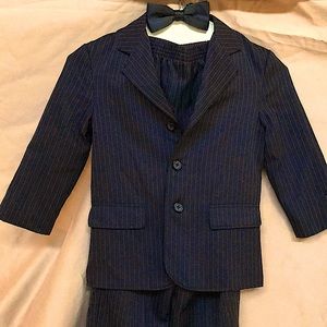 three-piece pinstripe black suit.